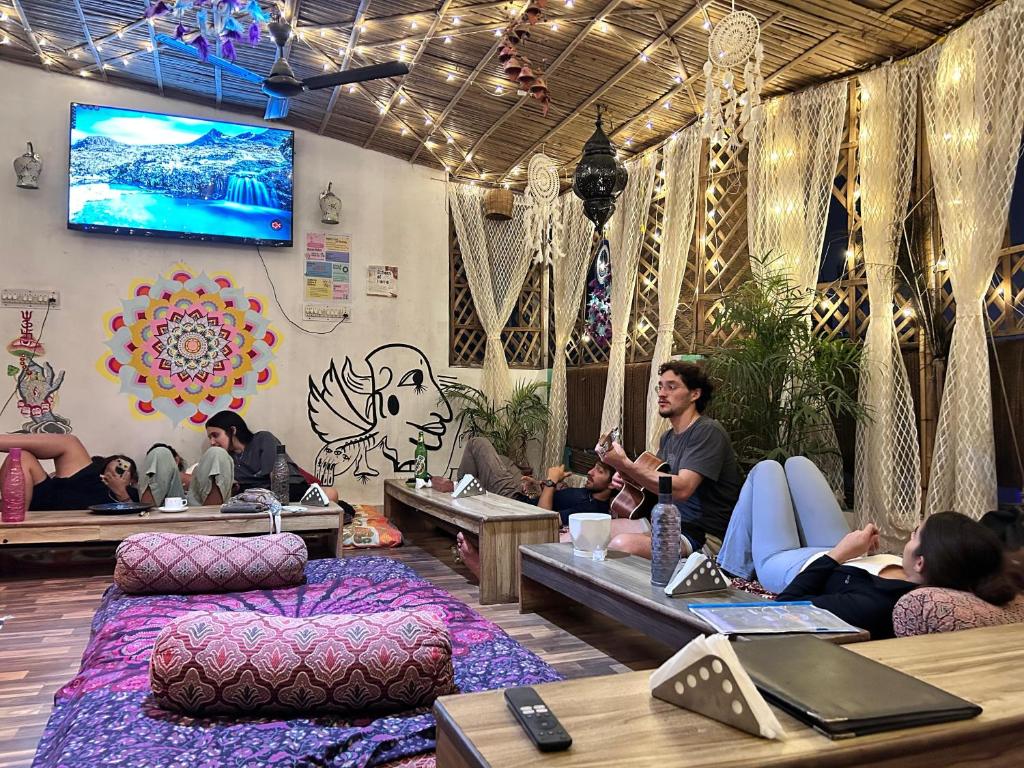 a group of people sitting in a room at Flamingos Hostel Jaipur in Jaipur