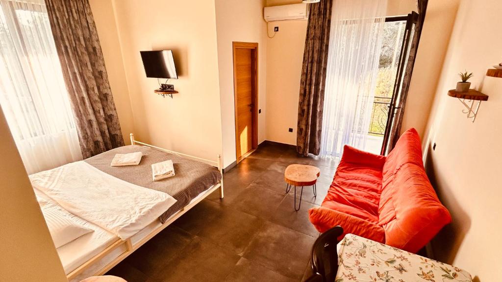 a small room with a bed and a couch at Eco Garden Kutaisi in Kutaisi