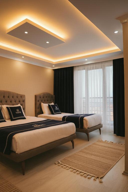 a bedroom with two beds and a large window at Loft House Studio in Arnavutköy