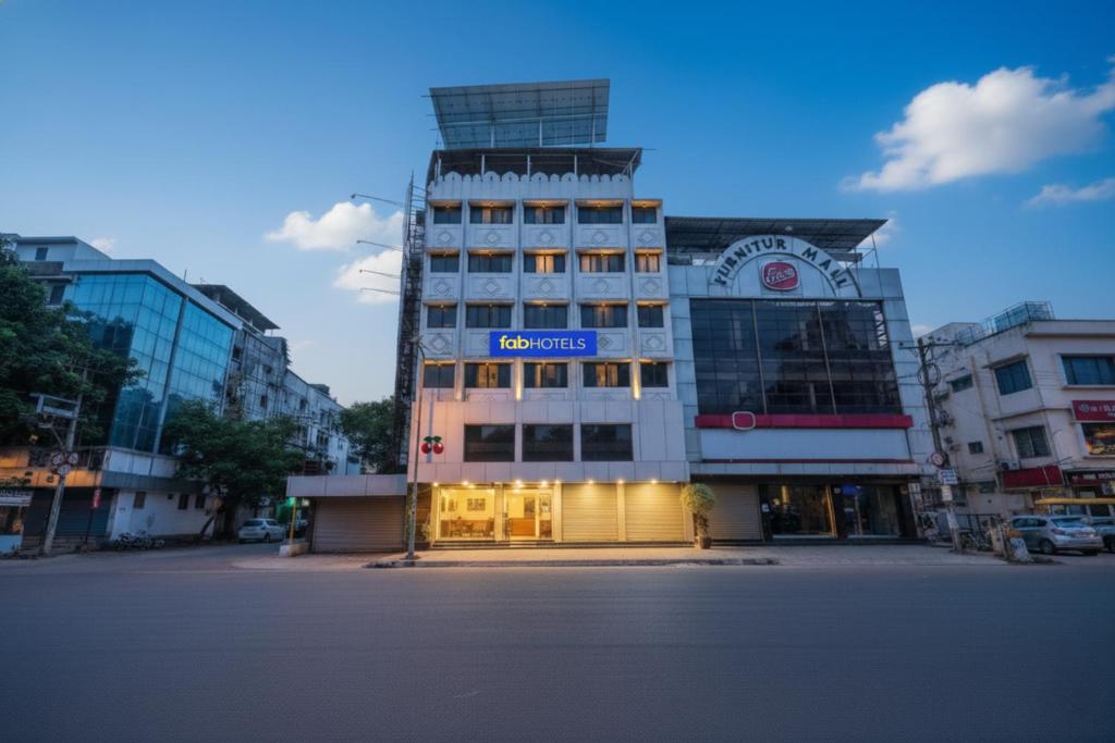 a tall building with a blue sign on it at FabHotel Shravan - Nr Eternity Mall in Nagpur