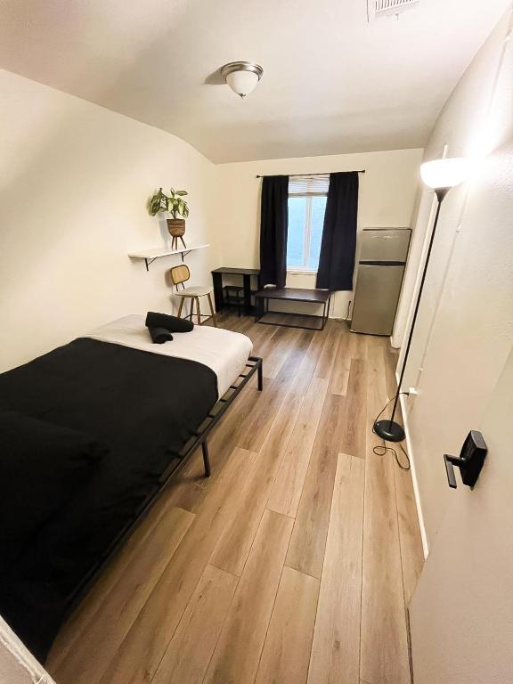 a bedroom with a bed and a wooden floor at Van Nuys Homes for the Soul in Los Angeles