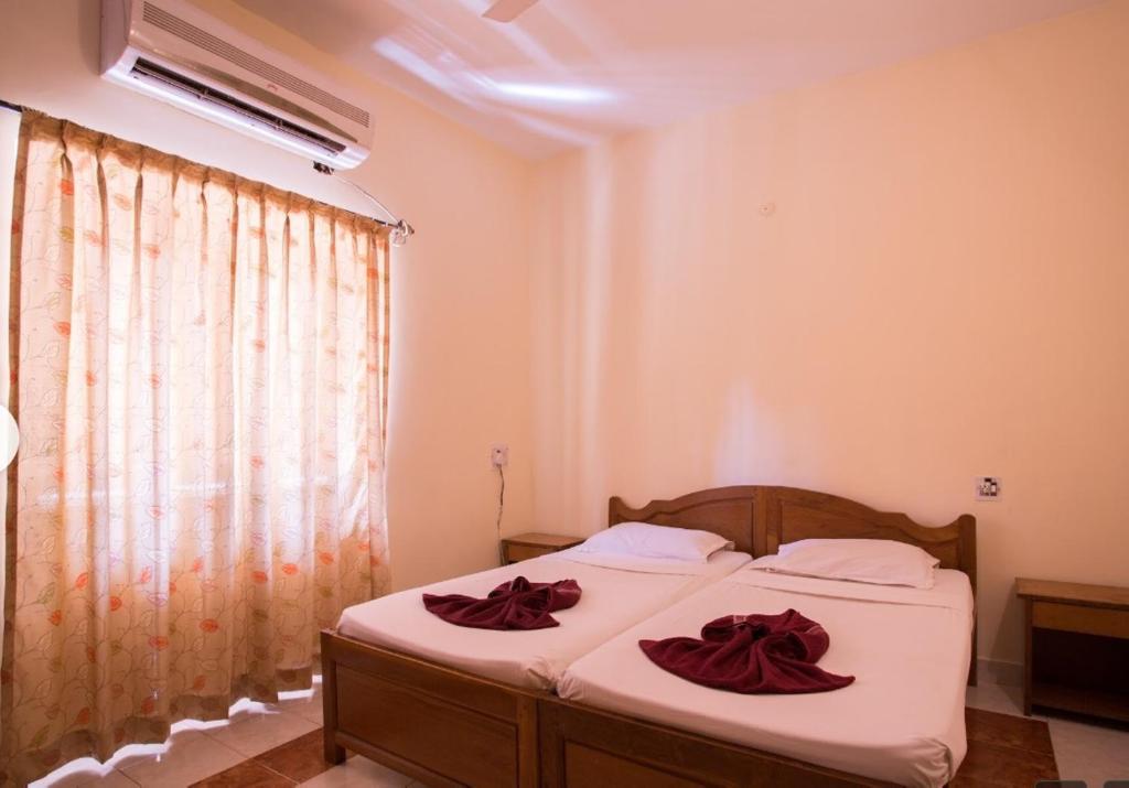 Ένα ή περισσότερα κρεβάτια σε δωμάτιο στο The Braganza Shoreline