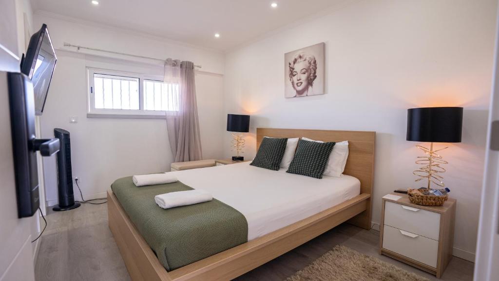 a bedroom with a bed and a television in it at KS near the airport in Lisbon
