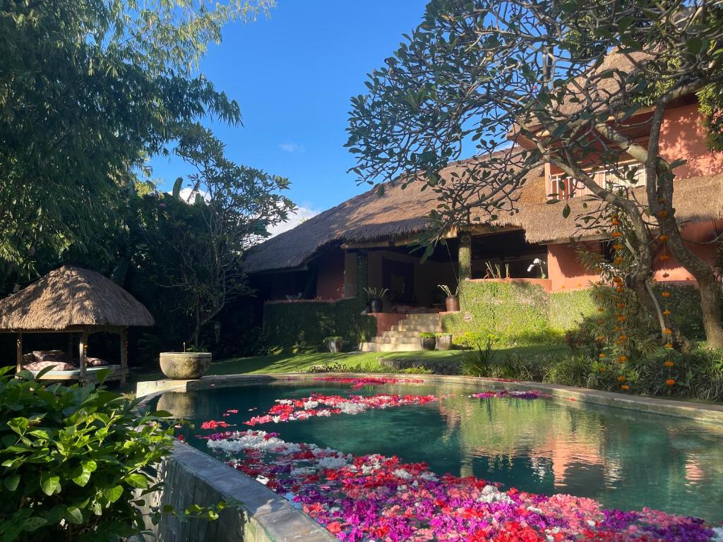 ein Blumenbecken vor einem Haus in der Unterkunft Villa Bella Bali - Authentic Balinese Luxury Villa with Tropical Elegance - Nanny and Cook in Canggu