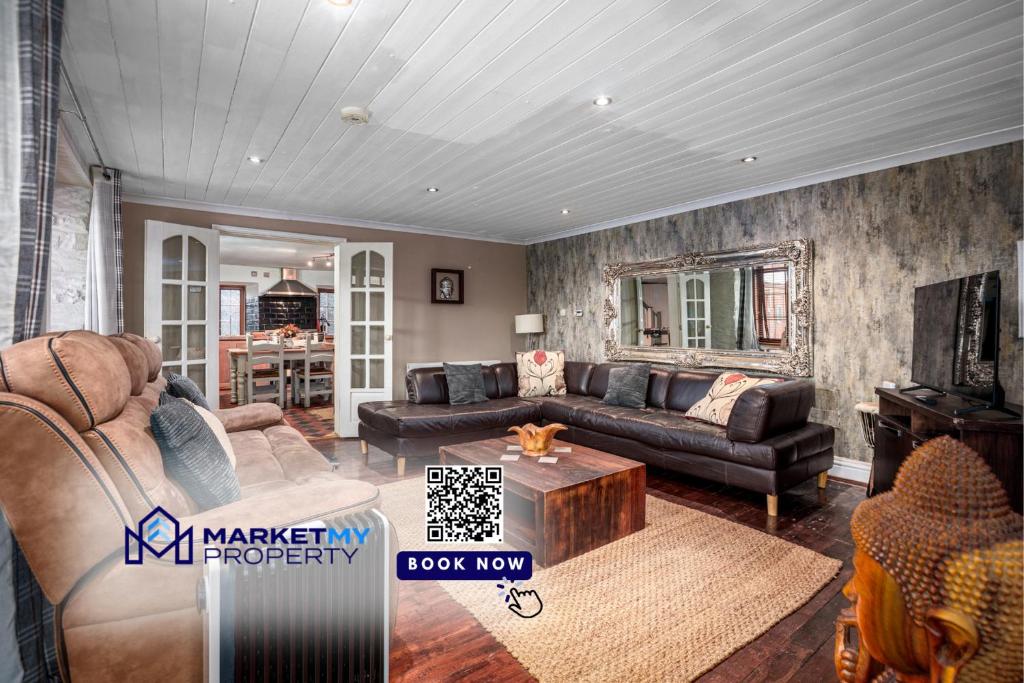 a living room with a couch and a table at The Old Bakehouse - Group Getaway in Llandysul