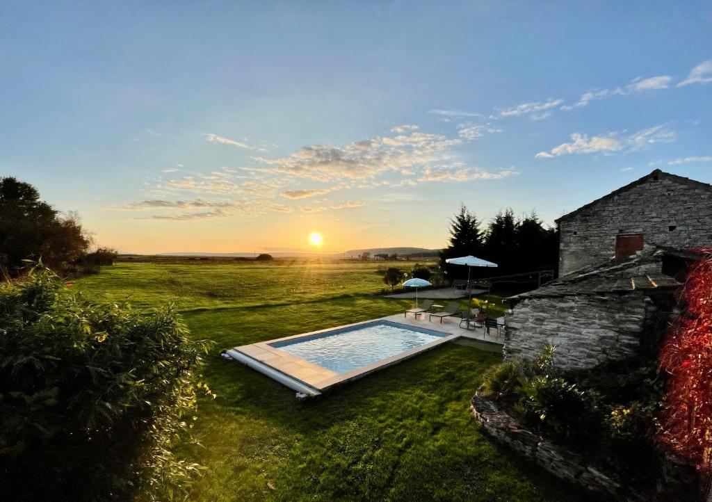 a backyard with a swimming pool and a house at le Couvent des Climats in Corgoloin