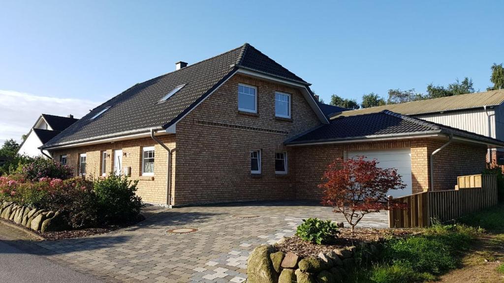 a large brick house with a garage at Lütt Gammelby in Gammelby