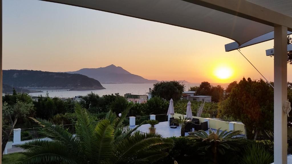a view of a sunset from a resort with a mountain at Belvedere in Procida