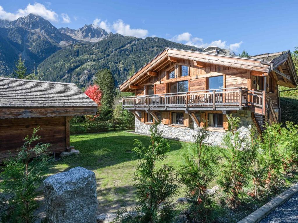 a log cabin with a balcony and a house at Luxueux Chalet avec Spa et Vue sur Mont Blanc - FR-1-343-253 in Chamonix-Mont-Blanc