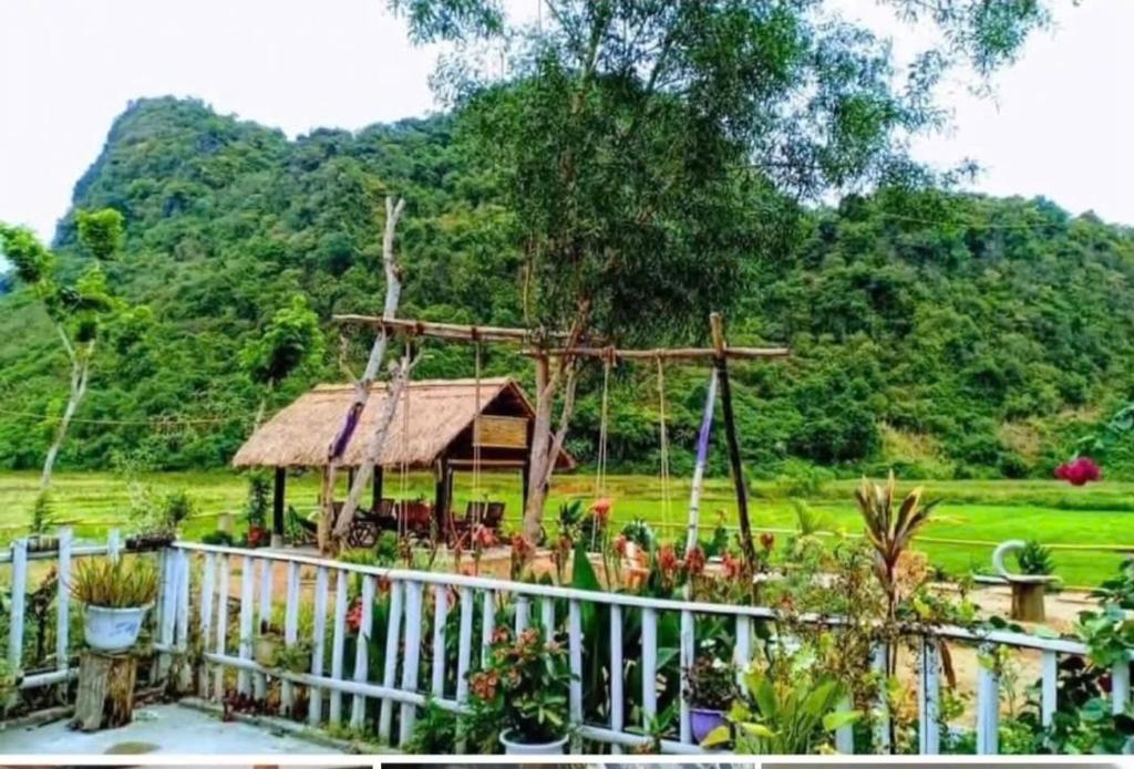 a garden with a gazebo in a field at Phong Nha Rice Field Homestay in Phong Nha