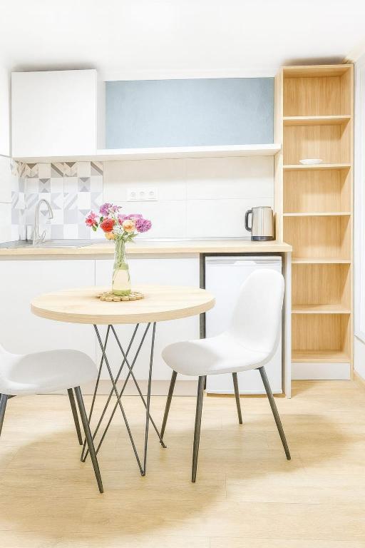 a kitchen with a table and two chairs at Maganiskhedi in Mtskheta