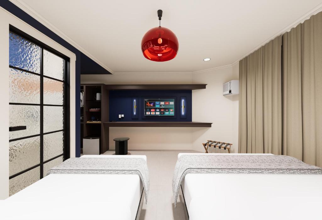 Ένα ή περισσότερα κρεβάτια σε δωμάτιο στο The Maximilian Hotel - Cebu