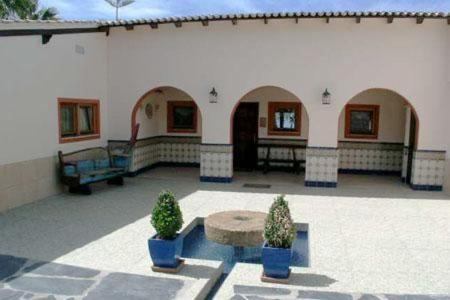 a patio with two potted plants in front of a building at Casa Alhambra 4 6 P in Guía de Isora