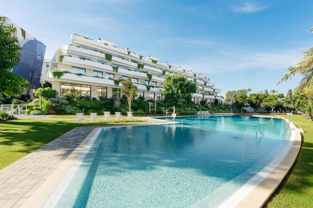 an image of a swimming pool in front of a building at Apartamentos - Delfin Natura in L'Alfas del Pi
