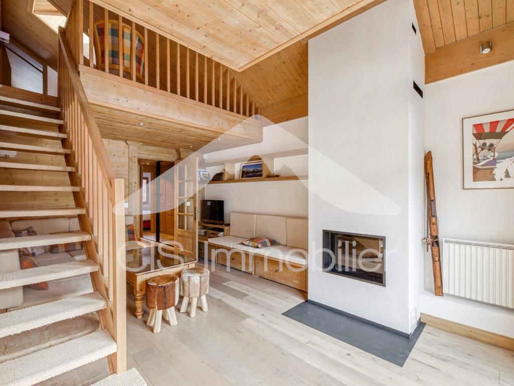 a view of the living room and staircase of a house at Appartement duplex lumineux, 4 pièces, 6 pers, Méribel centre, pistes et commerces à proximité - FR-1-411-736 in Les Allues