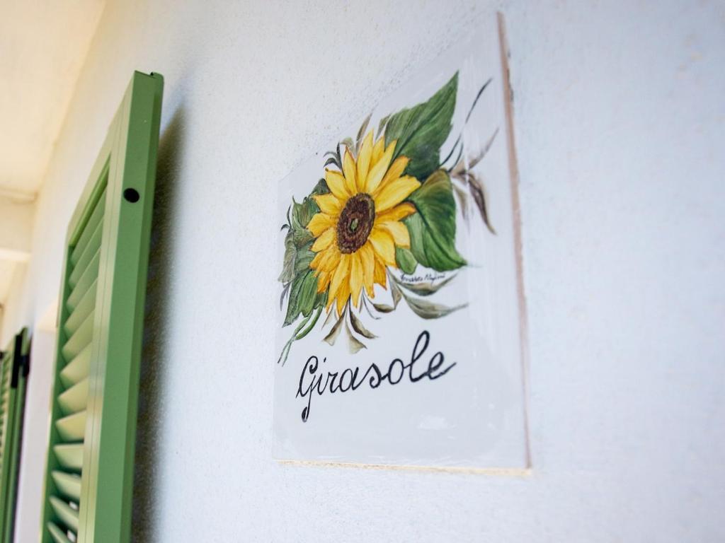 a picture of a sunflower on a wall at Corte Girodo - Appartamento Girasole in Rubiana