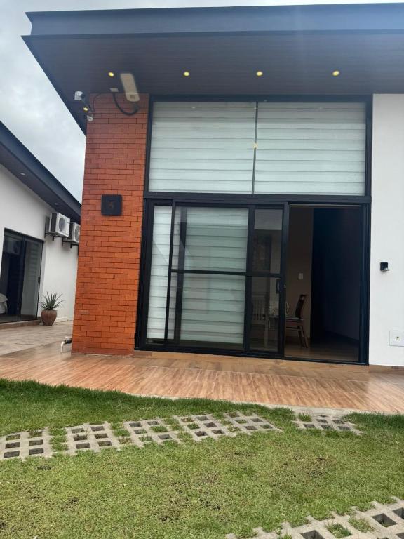 a house with a large window and a patio at Mar Adentro Casa 5 in Santa Cruz de la Sierra