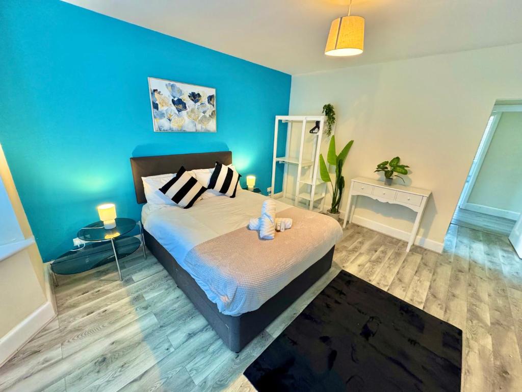 a bedroom with a bed with a teddy bear on it at Beachside Haven in Centre with Garden and Parking - 5 Mins Walk to The Beach in Bournemouth
