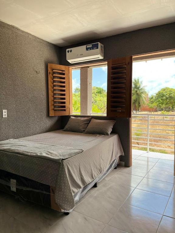 Ένα ή περισσότερα κρεβάτια σε δωμάτιο στο Pousada encantos morro branco