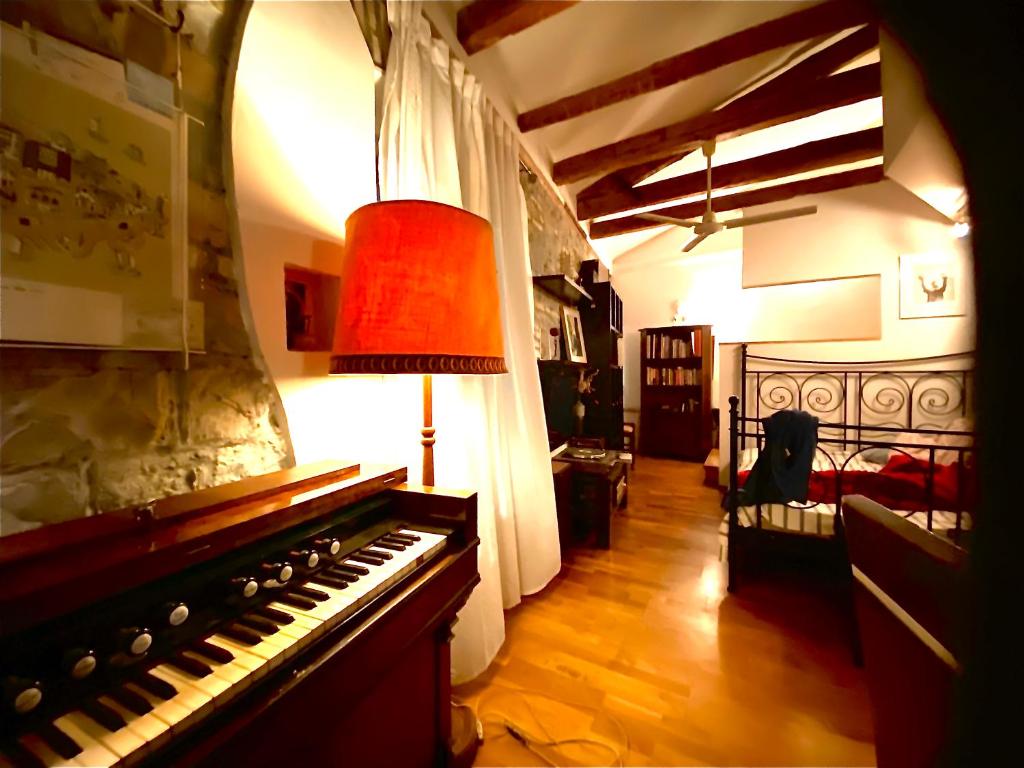 a living room with a piano and a lamp at Vojko Holidays in Koper