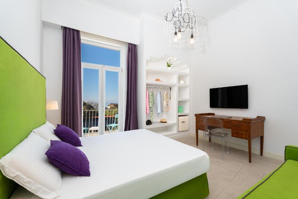 a bedroom with a bed and a desk and a window at Maison Ro' in Meta