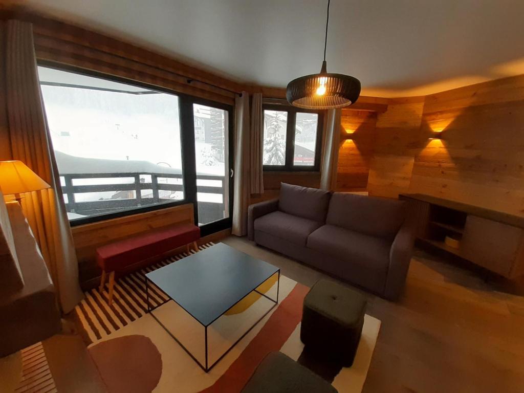 a living room with a couch and a table at Moderne 3 pièces, balcon sud, centre station, pied des pistes – Courchevel - FR-1-513-23 in La Tania