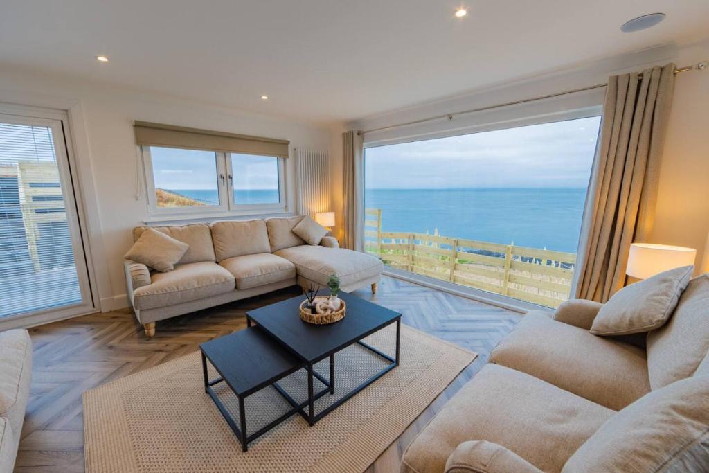 a living room with a view of the ocean at The View at Portpatrick. in Portpatrick