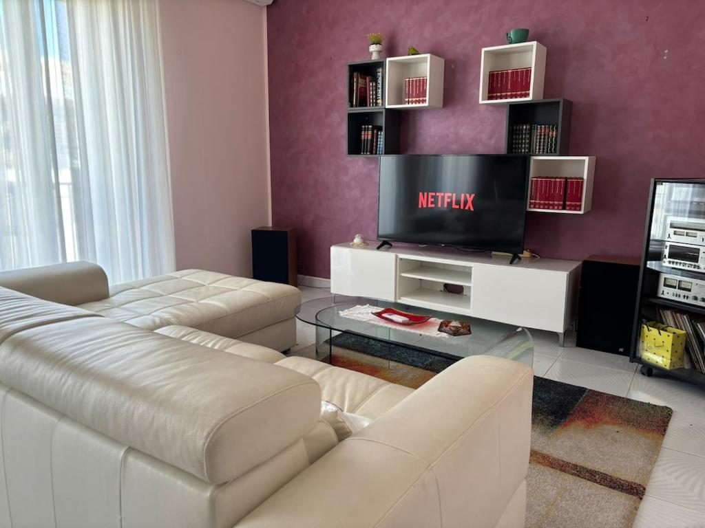 a living room with a couch and a tv at Mariuccia Home in Siracusa