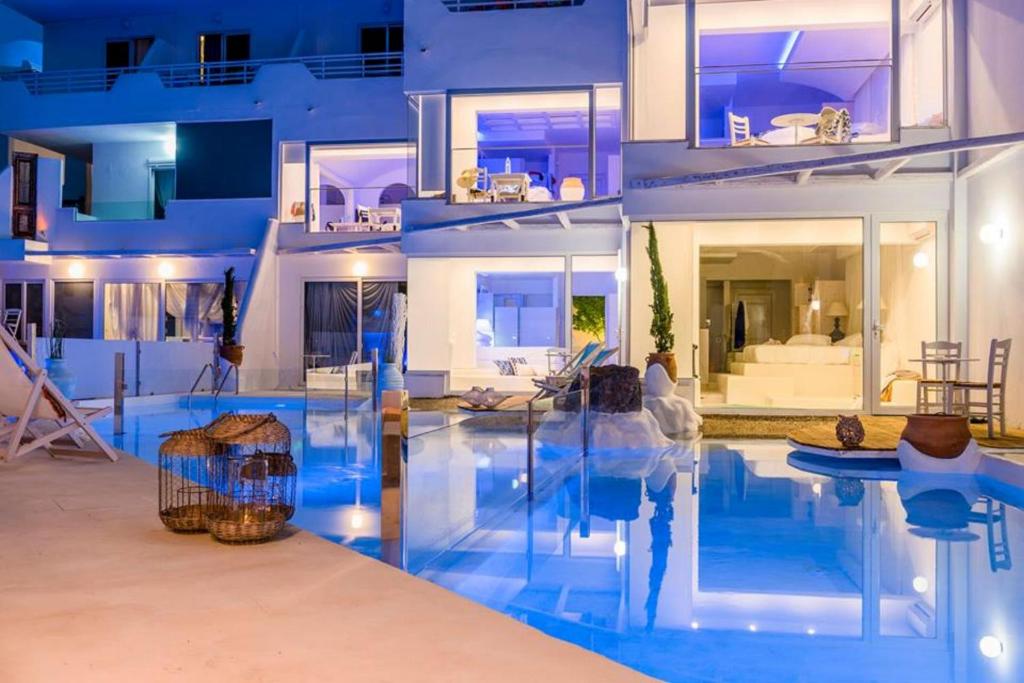 a house with a swimming pool in front of it at Kouros Home & Suites--Faliraki--Adults Only in Faliraki