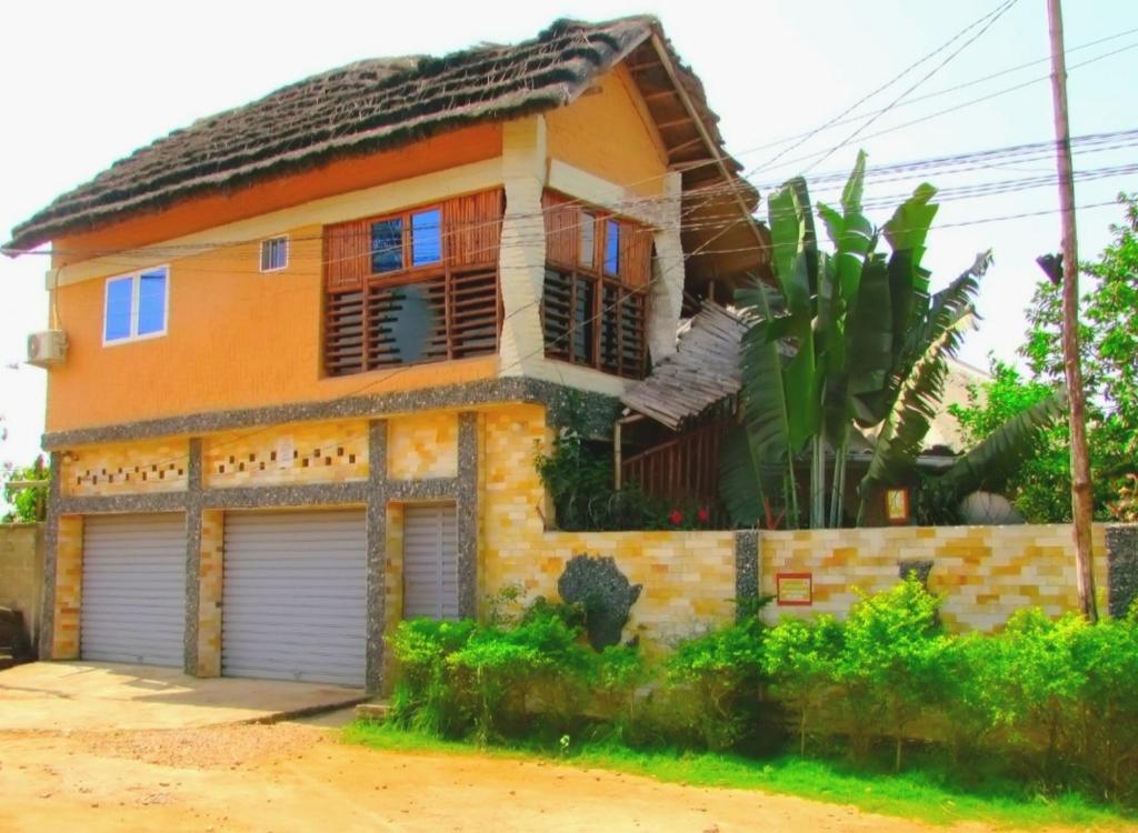 une maison avec deux portes de garage devant elle dans l'établissement appart OUR HOME, à Palimé