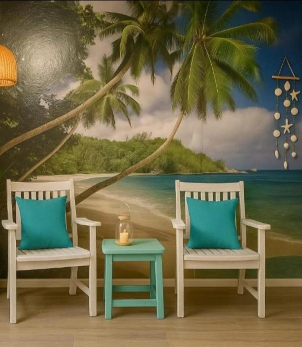 two chairs and a table in front of a beach at Arguinegin Gran Canaria Near the Beach with ocean view in Arguineguín