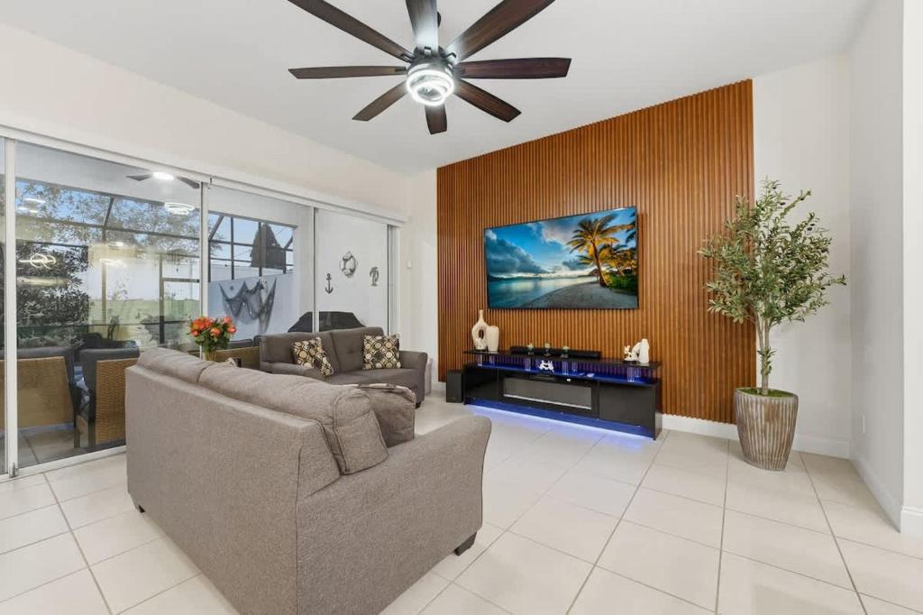 a living room with a couch and a ceiling fan at Tranquil Times Townhouse 4 bed Private Pool in Davenport