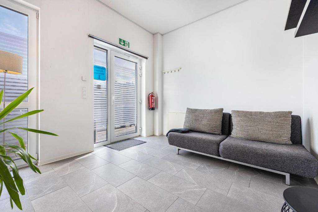 a living room with a couch and a window at Altenbeken- Ferienwohnung 1 in Altenbeken