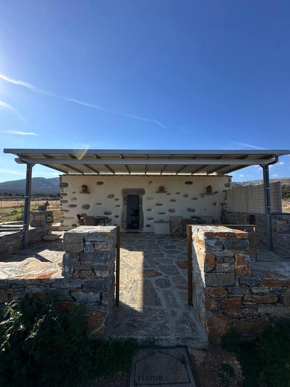 a building with a roof and a stone wall at Mitatos "Matthew" in Moutsoúna