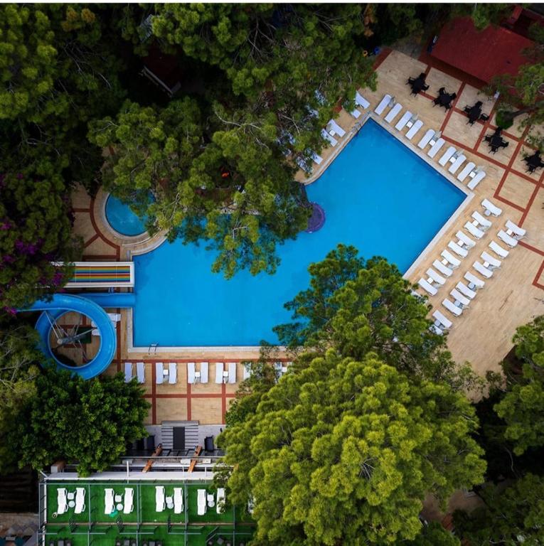 an overhead view of a large swimming pool with trees at Pirates Park Resort - All Inclusive in Kemer