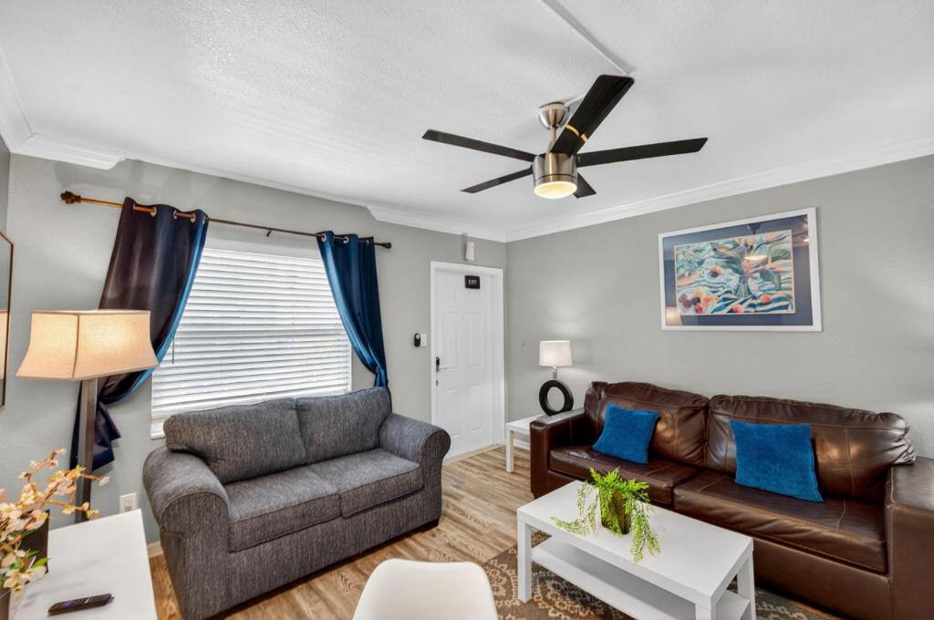 a living room with a couch and a ceiling fan at Sunset Beach Suites Unit 6 in St. Pete Beach