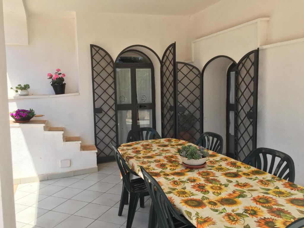 a dining room with a table and chairs and stairs at Trullo L'ulivo in Ostuni