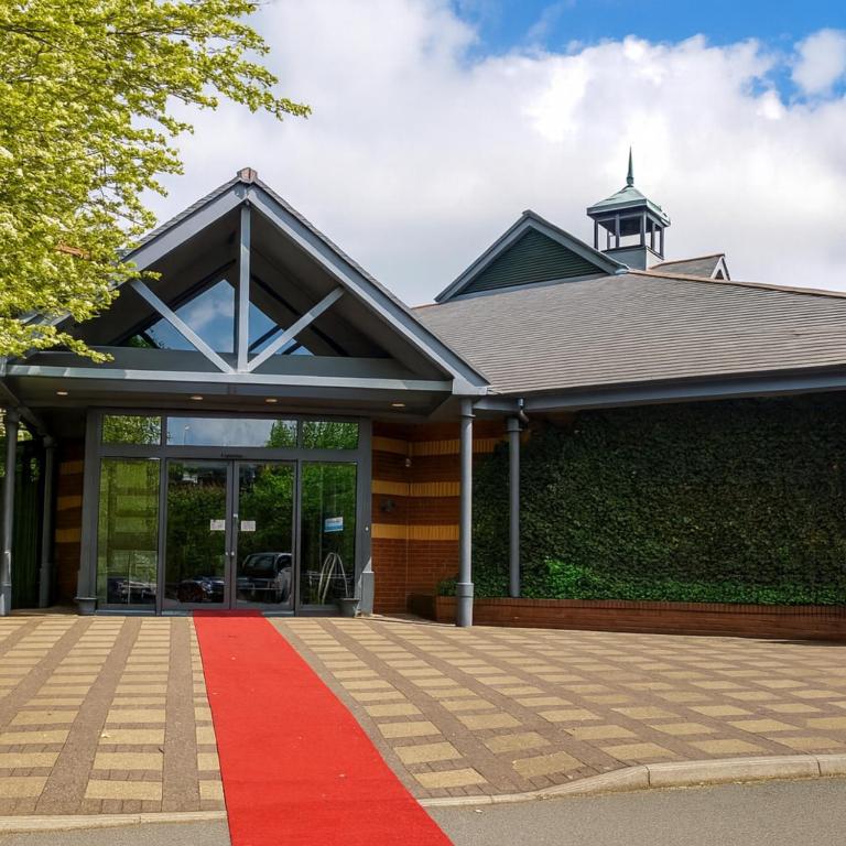 a house with a red carpet in front of it at Wigan Oak Hotel by Belvilla in Wigan
