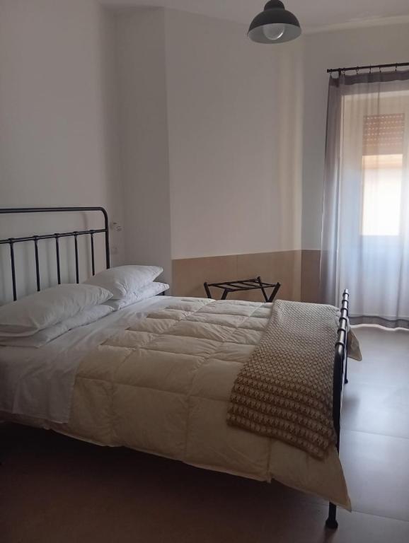 a bedroom with a large bed with a window at PETER PAN apartment in Salerno
