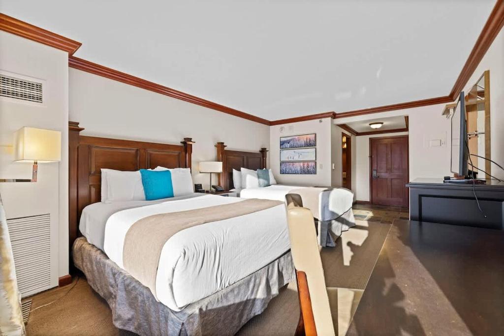 a hotel room with two beds and a television at Studio Suite 2 Queen Beds Mountain View in Tahoe City