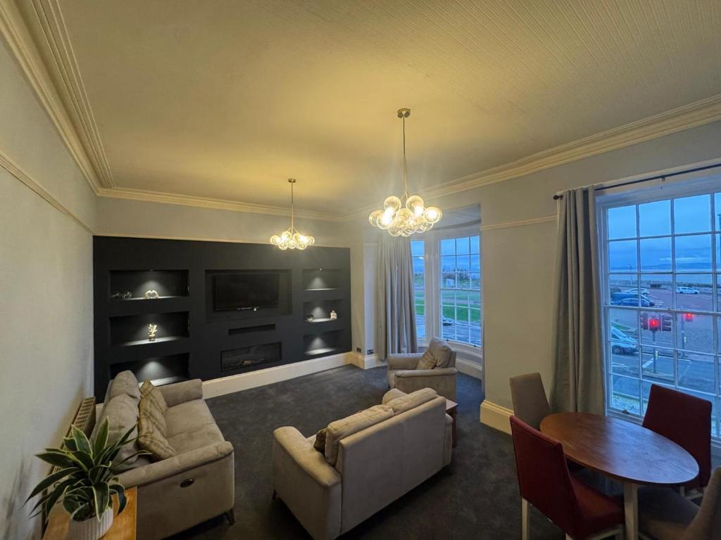 a living room with a couch and chairs and a table at Bay Apartment in Morecambe