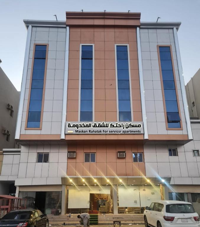 a building with cars parked in front of it at مسكن راحتك للشقق المخدومه in Tabuk