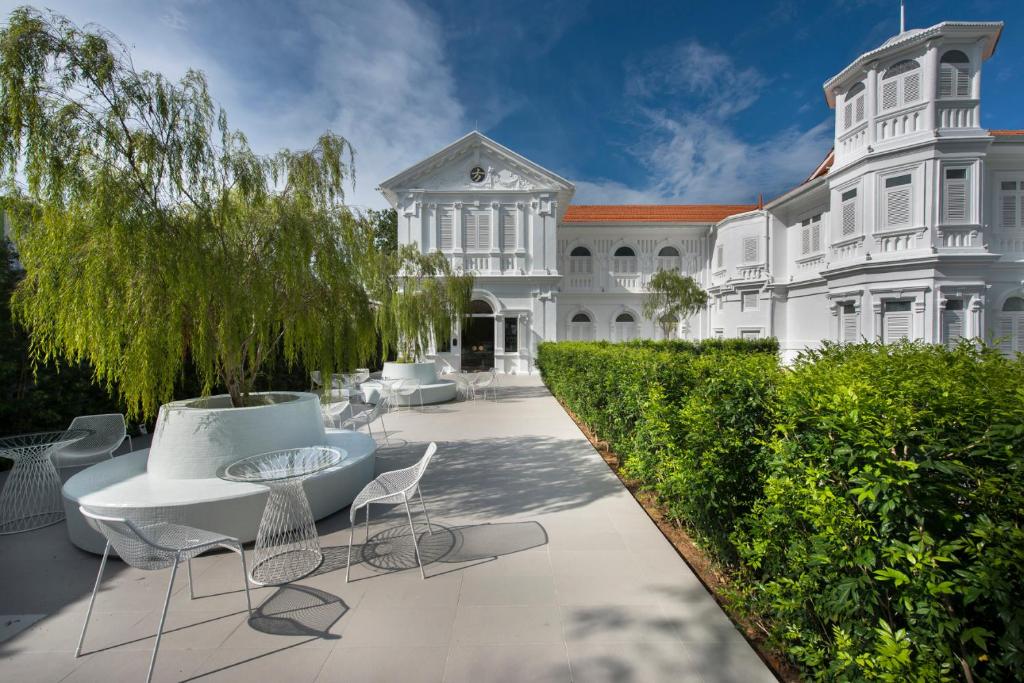 a large white mansion with a table and chairs at Macalister Mansion in George Town