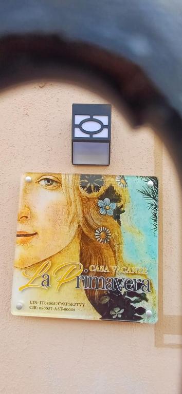 a sign on a wall with a picture of the olympics at la primavera in Palmi