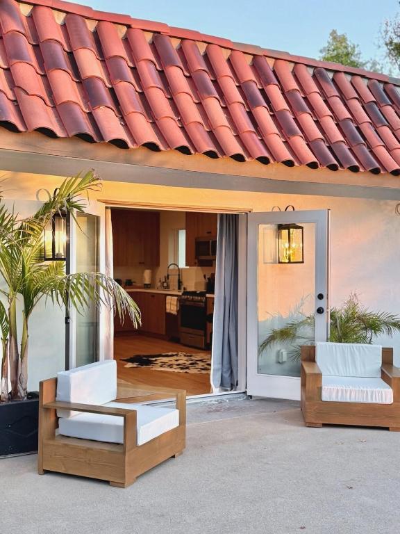 a house with a door open to a kitchen at Hillside Haven | Boutique Spanish Escape in Ojai