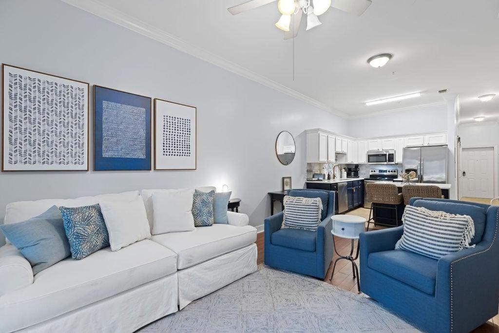 a living room with a white couch and blue chairs at Happy Days - Seagrove Highlands in Santa Rosa Beach