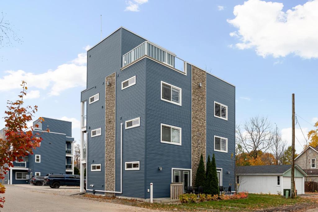 a large house with a blue building at Slabtown Penthouse - Modern Condo - Private Rooftop Deck 