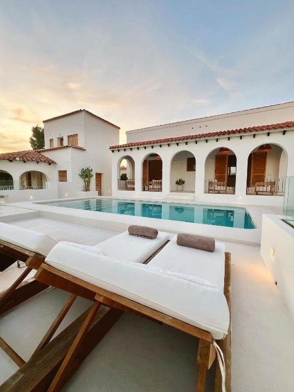 a villa with a swimming pool and a house at Casa Mimo Altea in Altea