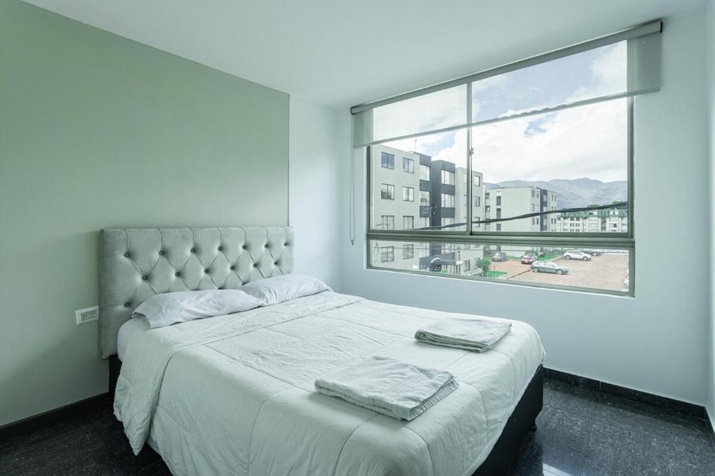 Ένα ή περισσότερα κρεβάτια σε δωμάτιο στο Hermoso apartamento en Calle 80 in Bogota
