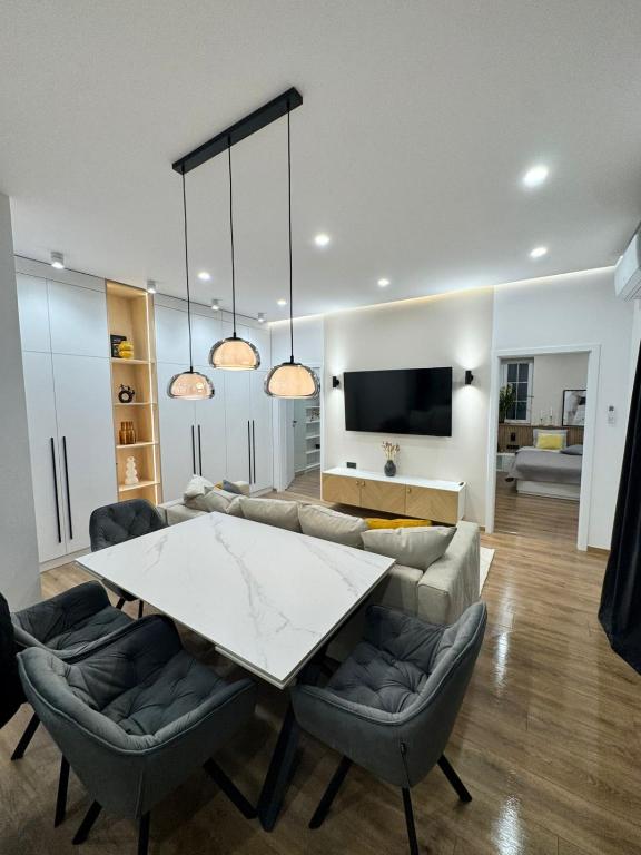 a living room with a table and a couch at Danubia-residence in Komárno